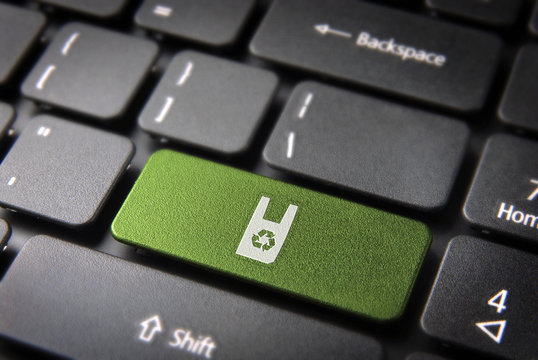 Green keyboard key with recycle plastic icon