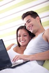 Loving couple with laptop