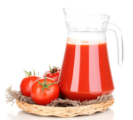 Tomato juice in pitcher on wicker mat isolated on white