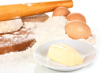 Eggs, flour and butter close-up isolated on white