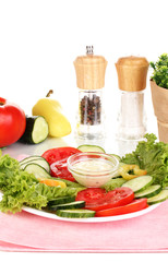 Chopped vegetables and sauce on plate isolated on white
