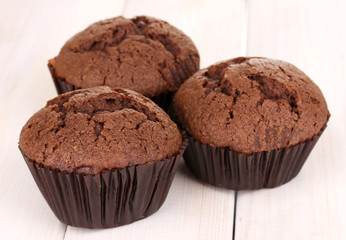 Fresh muffins on wooden background