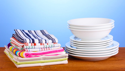 kitchen towels with dishes on blue background close-up