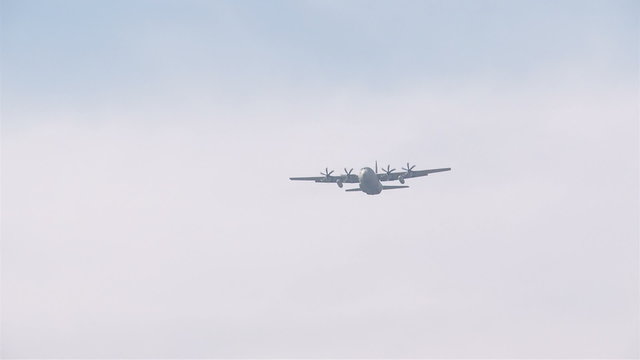 Military aircraft C-130 Hercules flying in the sky