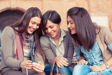 Three Women Looking Photos in the Camera