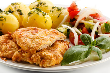 Pork chops, boiled potatoes and vegetable salad