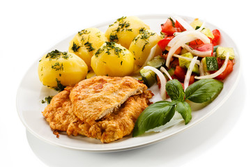 Pork chops, boiled potatoes and vegetable salad