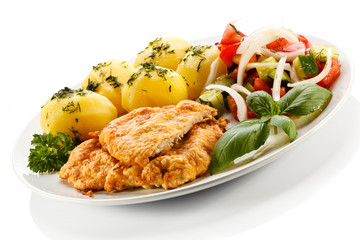 Pork chops, boiled potatoes and vegetable salad