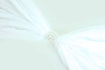 White cloth tied with pearls isolated on white