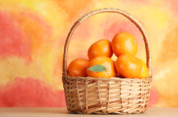 tangerines with leaves in a beautiful basket,