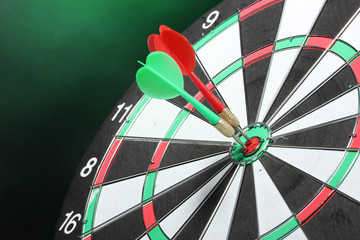dart board with darts on green background