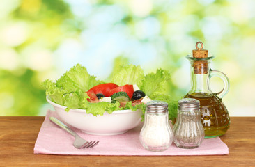 tasty greek salad on bright green background