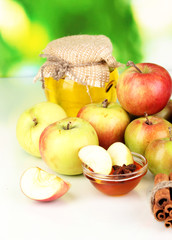 Honey and apples with cinnamon on natural background