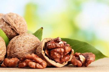 walnuts with green leaves, on green background