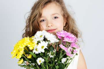 portrait of a beautiful little girl with flowers