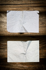 Faded blank paper sheets on wood