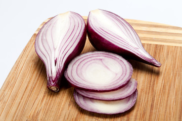 Red onions on a wooden board
