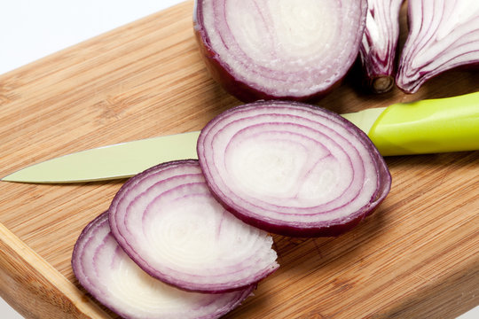 Red onions on a wooden board