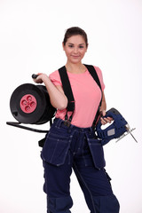 Fototapeta premium craftswoman holding a drill