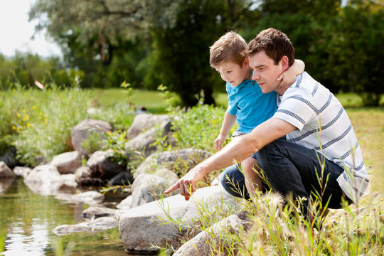 Fashing and Son Playing Near Lake