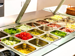 Tray with  food  on showcase at cafeteria