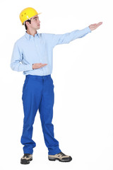 Builder gesturing into distance