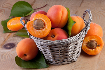 apricots in basket on wood background