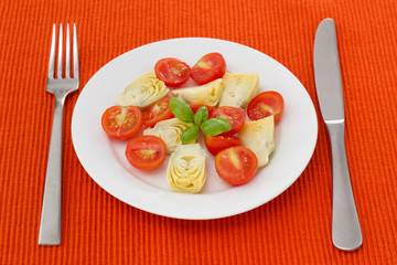 salad with artichoke on the white plate