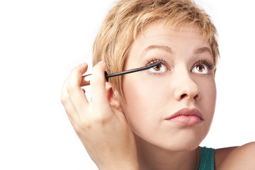 Woman paints the eyelashes