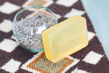 lavender in bowl and soap on ethnic mat