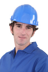 Man in blue overalls and hardhat