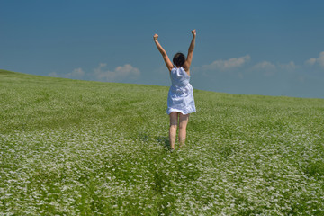 Fototapeta premium Young happy woman in green field