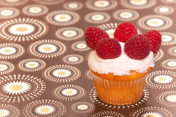 cup cake with raspberries