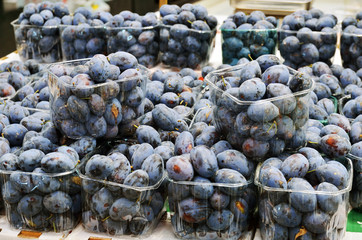 Close up of plums on market stand