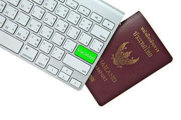 Green vacation button on computer keyboard with Thai passport is