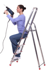 a woman using a power drill