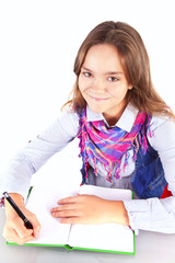 smiling girl doing homework isolated over white backgorund