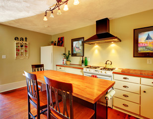 Craft cozy White kitchen with green walls and hardwood floor.
