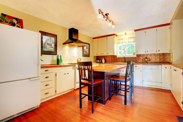 Craft cozy White kitchen with grey walls and hardwood floor.