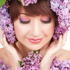 Young woman with lilac flowers