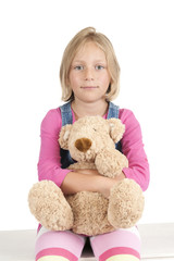 girl with teddy bear on white