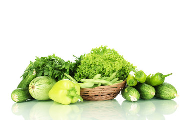fresh green vegetables in basket isolated on white