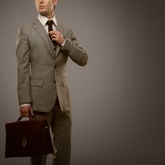 Businessman with a briefcase isolated on grey