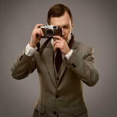 Businessman with a retro camera