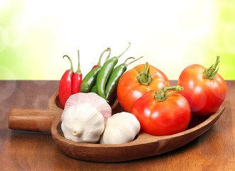Tomatoes, garlic, and pepper in  wooden bowl