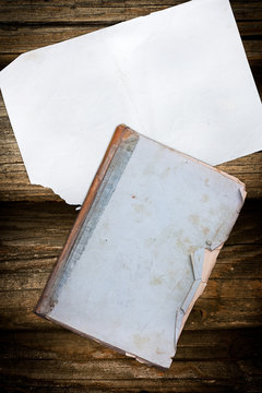 Old book and paper on wood