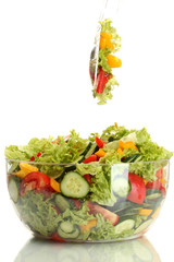 fresh vegetable salad in transparent bowl with spoon and fork