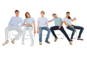 teenagers sitting on chairs