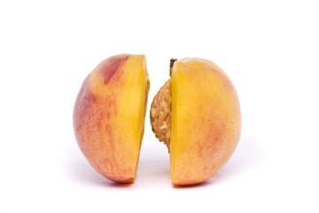 tasty peach sliced on half on white
