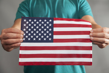 Obraz premium Two Hands Holding Flag